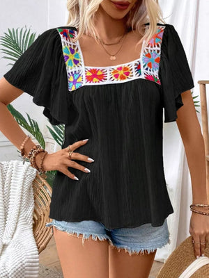Black embroidered square neck blouse with flutter sleeves and colorful floral detail.