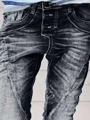 Dark blue cuffed button-fly jeans with a distressed wash and white stitching.