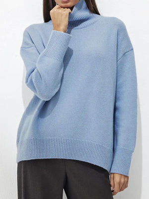 Light blue acrylic turtleneck sweater with sculptural sleeves and ribbed cuffs and hem.