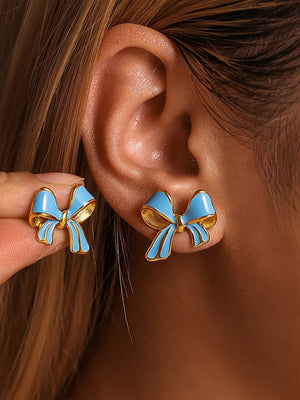 Sky blue enamel bow stud earrings with gold detailing.