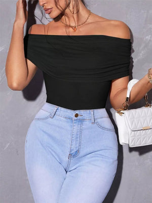Black off-shoulder ruched t-shirt with short sleeves, styled with light wash jeans.
