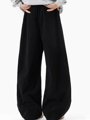 Men's black pleated wide leg trousers with elastic waistband