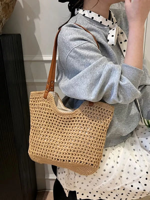 Beige woven straw shoulder bag with leather straps and open crochet detail.