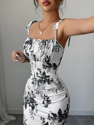 Floral print tie strap maxi dress in white with black floral pattern, square neckline, and ruched detail.