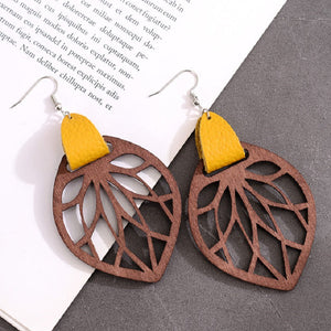 Brown wood leaf cutout dangle earrings with yellow leather accent