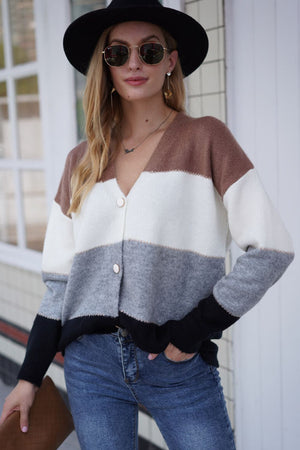 Colorblock acrylic cardigan with metallic trim, button front, v-neck, and long sleeves.