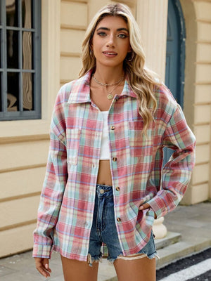 Collared long sleeve plaid shirt with button front and pockets.