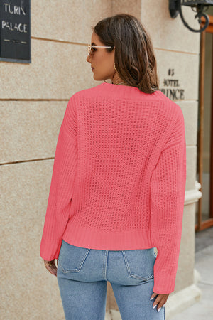 Cross-front ribbed knit sweater in strawberry with a relaxed fit and crew neck.
