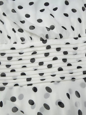 Charming Ruched Halter Neck Mini Dress in white with black polka dots and ruched detail.