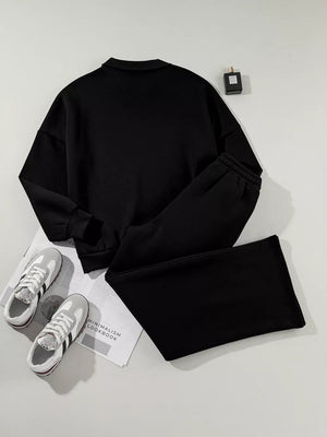 Black zip-up jacket and drawstring pants set, comfortable cotton activewear.