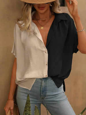 Colorblock silk-effect collared blouse in black and ivory with button front and short sleeves.