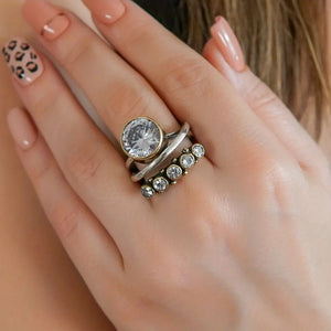 Silver and gold tone ring set with clear rhinestones and a large crystal accent.