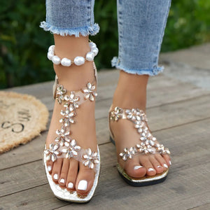 Floral embellished PVC sandals in white with clear straps and crystal flowers.
