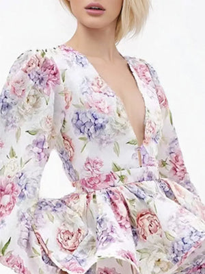 Blooming ruffle mini dress with a plunging neckline and floral print.