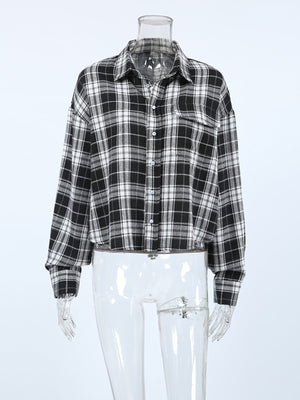 Oversized black and white plaid cotton button-up shirt with collar and chest pocket.
