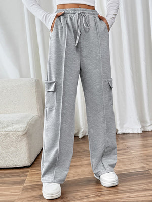 Gray cargo pocket wide leg sweatpants with drawstring waist and seam detail.