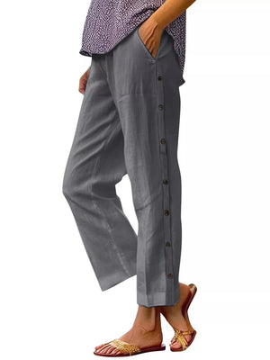 Dark gray relaxed fit pants with decorative buttons down the side and pockets.
