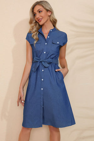Tie-waist denim shirt dress in royal blue with pockets and short sleeves.