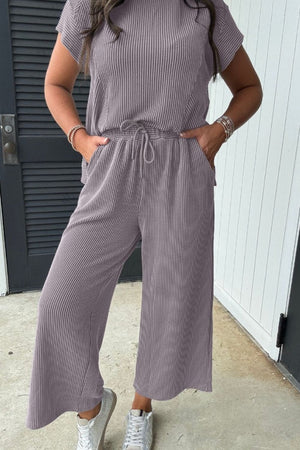 Gray ribbed knit drawstring co-ord set with cropped pants and short sleeve top.