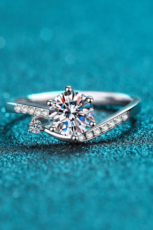Silver bypass ring with a large center moissanite and pavé accents.
