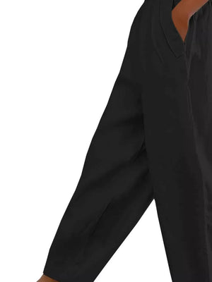Black wide-leg maternity pants with pockets, showing a close-up of the side seam and pocket detail.