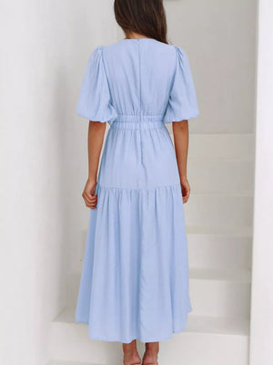 Light blue midi dress with puff sleeves, elastic waist, and tiered skirt.