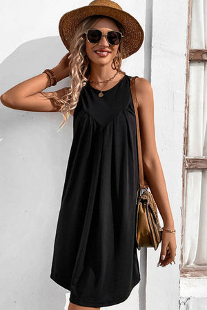 Black sleeveless trapeze dress with pleated yoke detail