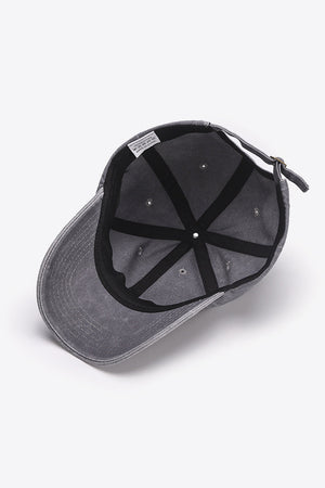 Washed cotton baseball cap in gray with adjustable strap and interior label.