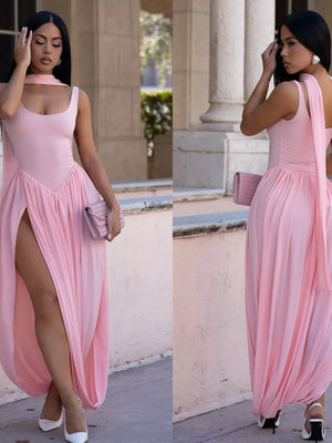Blush pink scoop neck maxi dress with a high slit and draped skirt.