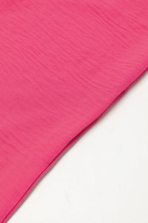 Oversized shirt romper in hot pink with textured fabric detail.