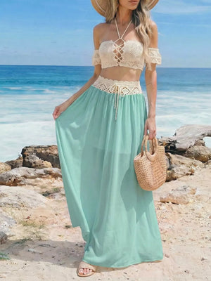 Crochet bandeau top and pastel blue maxi skirt with cutout details and lace-up front.
