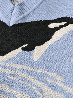 Misty blue V-neck sweater with black and white orca motif knit pattern.