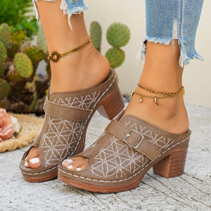 Tan block heel sandals with buckle and floral embroidery, peep toe.