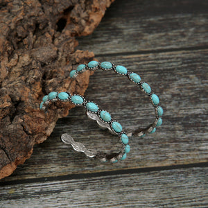 Textured turquoise stone hoop earrings with alloy metal detail.