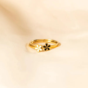 Delicate floral enamel rings in gold with white and black flower details