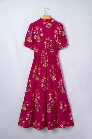 Charming floral tiered midi dress with ruffled neckline and sleeves, smocked waist, and cotton fabric.