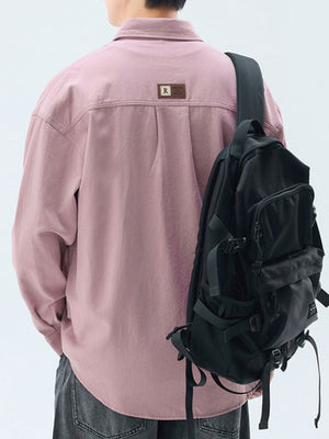 Men's pink cotton casual button-up shirt with back pleats and a leather patch detail.