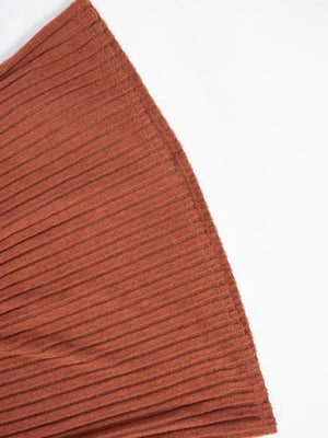 Ribbed knit A-line dress in rust orange with long sleeves and a textured finish.