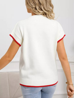 White acrylic knit top with red ribbed crew neck, cuffs, and hem