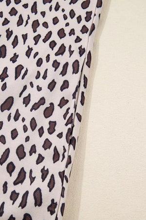 Leopard print mini dress with zip-up collar detail in cotton fabric.