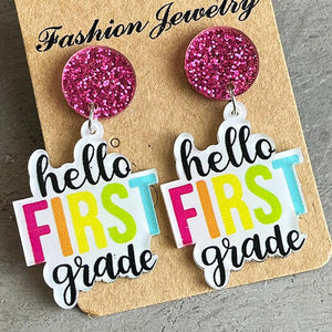 Second Grade Graphic Drop Earrings with pink glitter tops and "hello FIRST grade" text.