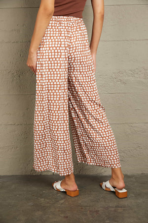 Polka dot wide leg culottes in brown with white dots, featuring an elastic waistband.