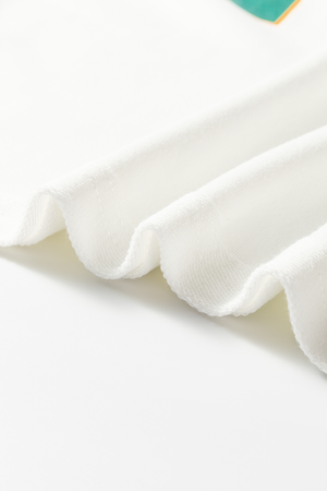 White raglan sleeve sweatshirt fabric detail, showing textured knit and soft drape.
