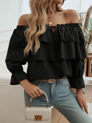Black tiered ruffle off-shoulder blouse with tie neck and bell sleeves.