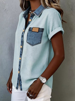 Heathered light blue short sleeve maternity shirt with denim accents and button front.