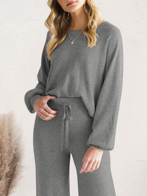 Dark gray acrylic loungewear set with wide-leg pants and a crewneck sweater.