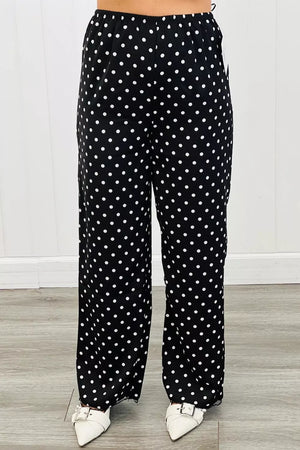 Chic polka dot wide-leg maternity trousers in black with white dots.