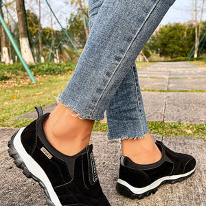 Black suede-like slip-on sneakers with white soles and "Sport" and "Outdoor" details.