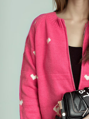 Hot Pink zip-through knit cardigan with white heart appliqué, acrylic fabric.