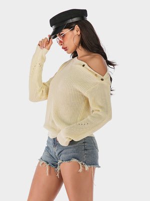Beige knit sweater with shoulder-baring neckline and button detail.